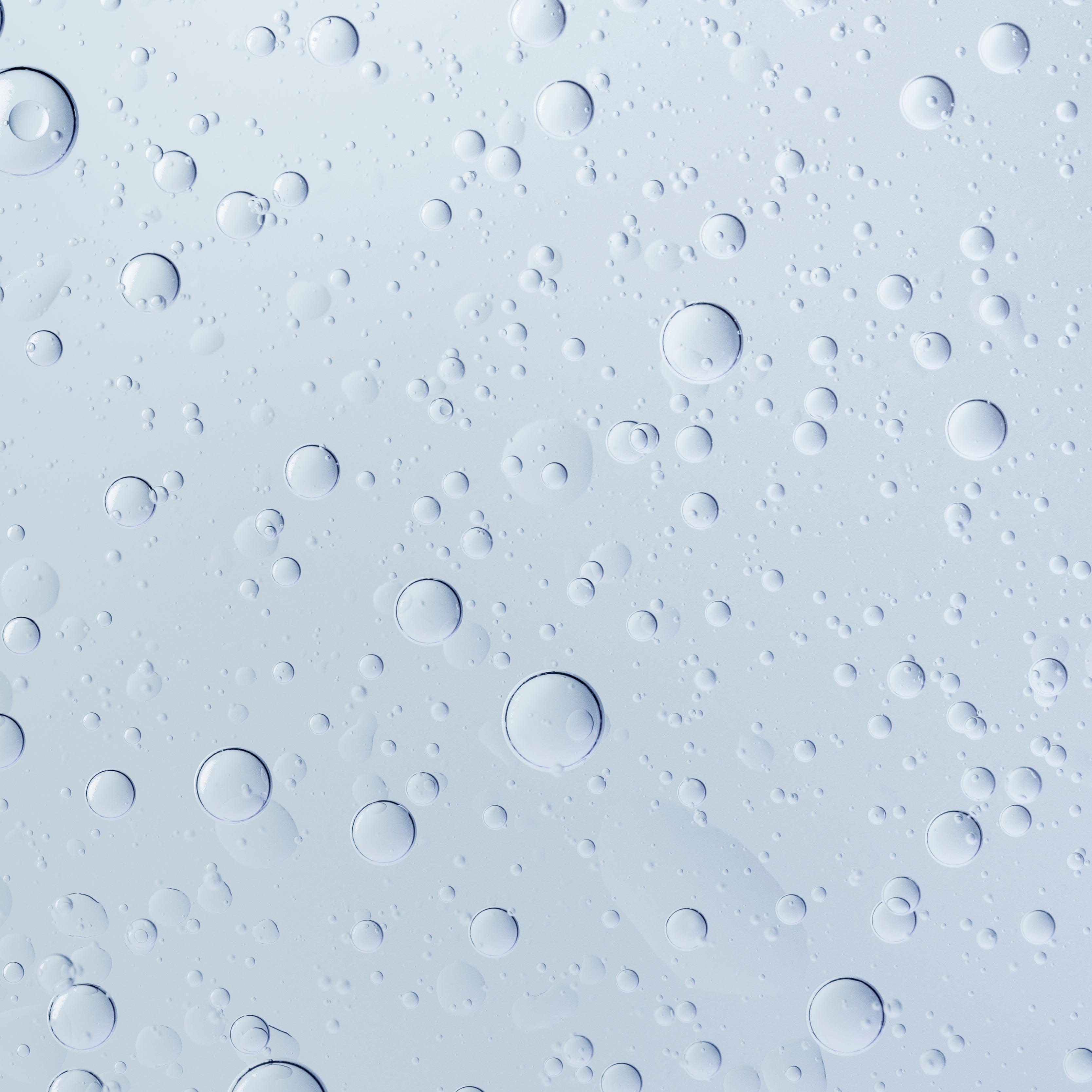 Pattern of water droplets on a light blue background
